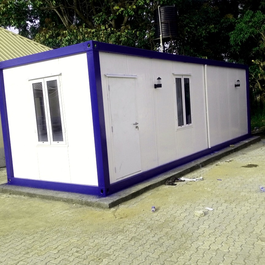 Long purple and white panel store building with lockable doors